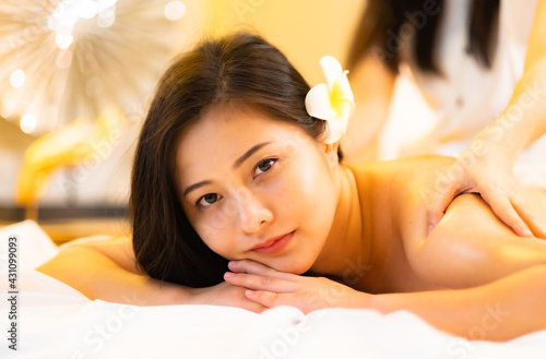 Asian Beautiful young and healthy woman in spa salon. Massage treatment spa room.Traditional medicine and healing concept.