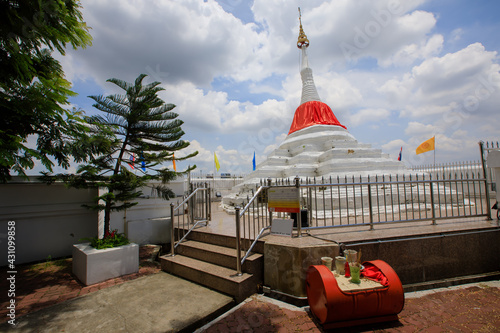 Tilt pagoda in Ko Kret. Wat Poramai Yikawat, on the island of Ko Kret (also Koh Kred), a Mon temple in (Myanmar), with red material wrapped around it, in  Nonthaburi Province Thailand.
