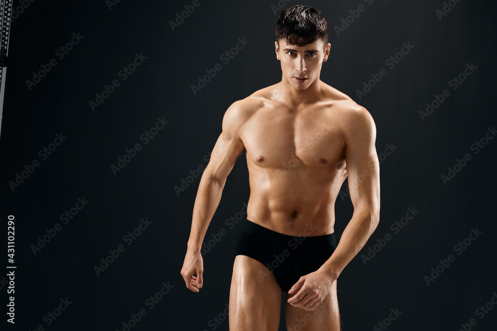 Attractive Athletic Man In Dark Briefs Studio Posing Attractive Athletic Man In Dark Briefs Studio Posing