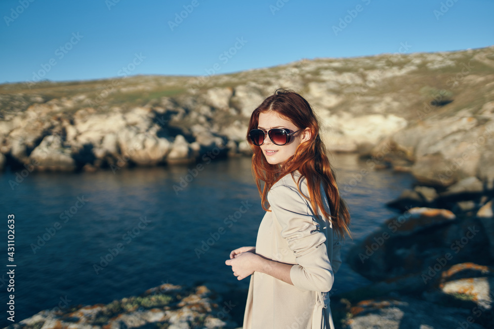 traveler near the sea in the mountains in nature and blue sea clouds sky traveler near the sea in the mountains in nature and blue sea clouds sky