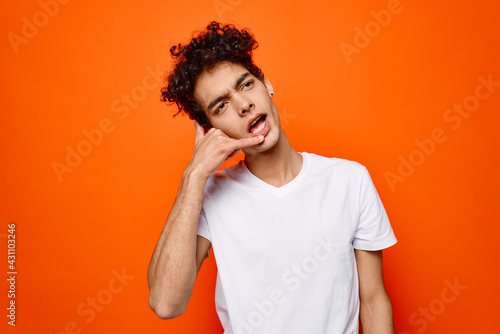 Cheerful man white t-shirt gestures with hand emotions fashion