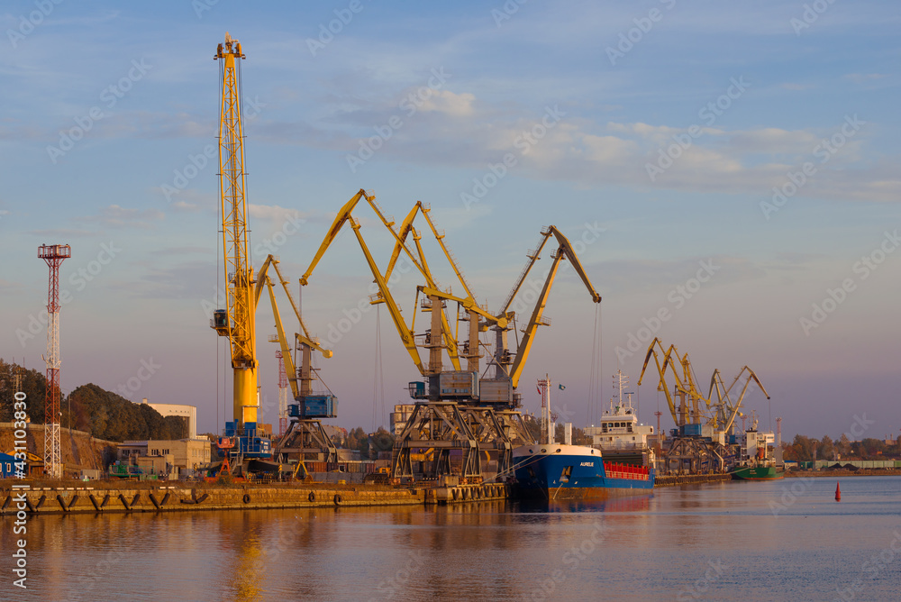 View of the berths of the Vyborg cargo port on a sunny October evening