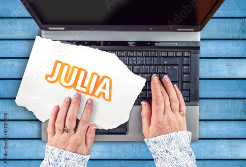 Photos Julia Programming Language.  Word Julia on paper and laptop