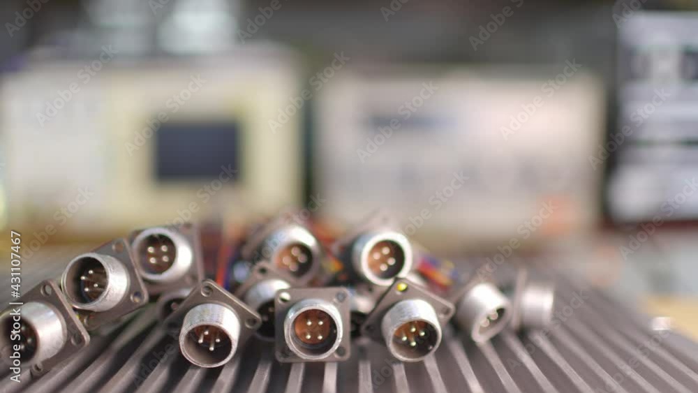 Slider shot video of blurry metal sockets for plugs are in a heap. Concept for the production of computer televisions and audio speakers Slider shot video of blurry metal sockets for plugs are in a heap. Concept for the production of computer televisions and audio speakers