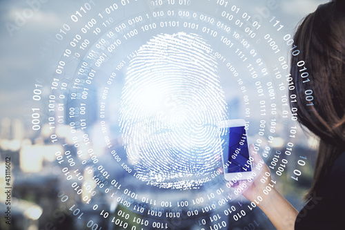 Double exposure of fingerprint hologram and woman holding and using a mobile device. Security concept.