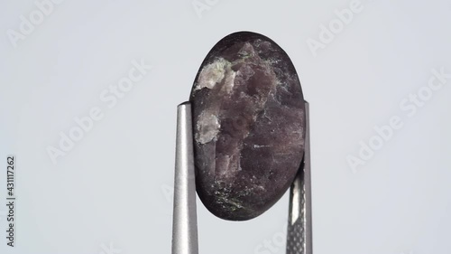 natural scapolite gemstone on the white turning table photo