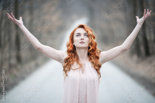 redhead girl posing outside