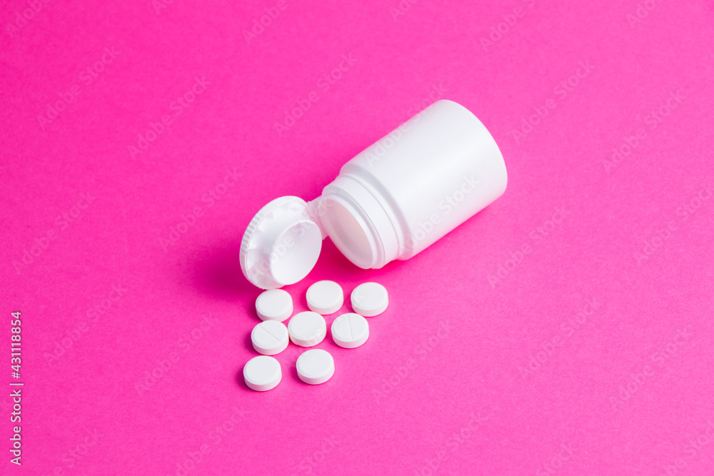 Flatley, white pills and jar on pink paper background copy space. Flatley, white pills and jar on pink paper background copy space.
