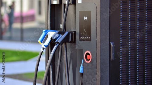 Electric car charging station. Transport plug and fuel recharge. Future energy power and green technology.  