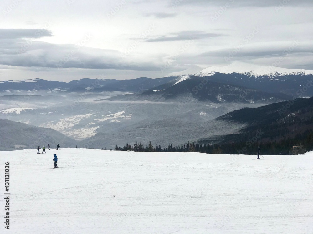 people ski overlooking the cloud in the valley