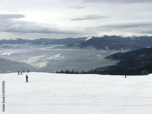 people ski overlooking the cloud in the valley