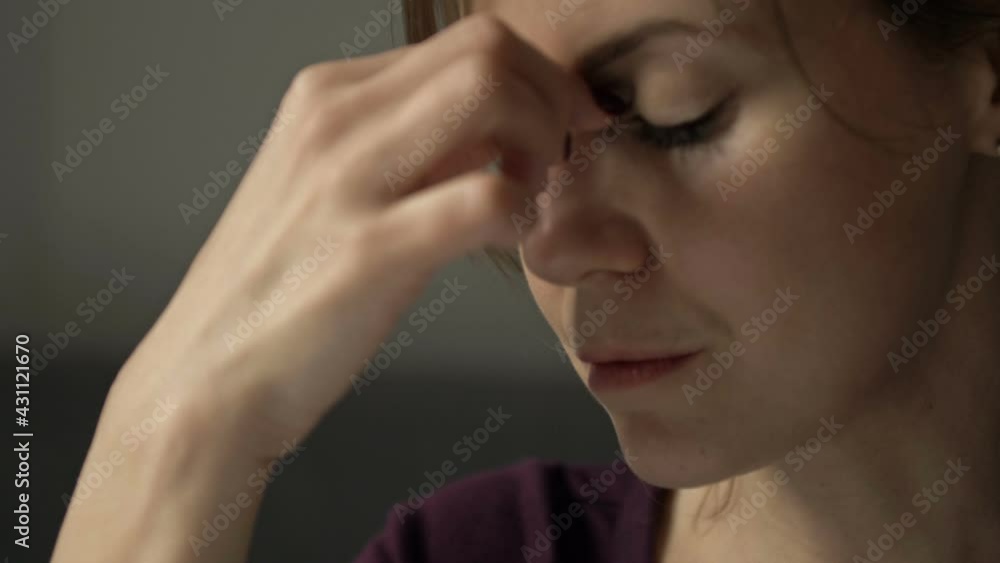 Portrait of a woman rubbing her eyes and the bridge of her nose. Feels tired after wearing glasses for a long time. Portrait of a woman rubbing her eyes and the bridge of her nose. Feels tired after wearing glasses for a long time.