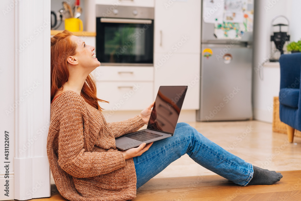 Happy young woman relaxing with a laptop computer Happy young woman relaxing with a laptop computer