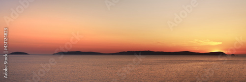 Isla de ons in the ria de pontevedra at sunset with the sun setting just behind