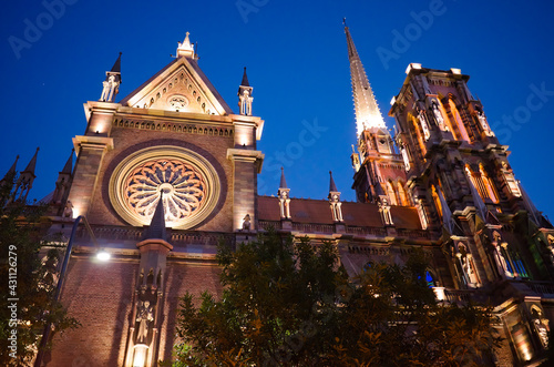 Side view of gothic church called Iglesia del Sagrado Corazon de Jesus also known as Iglesia de los Capuchinos located in Cordoba, Argentina. Catholic church illuminated with backlight at night time