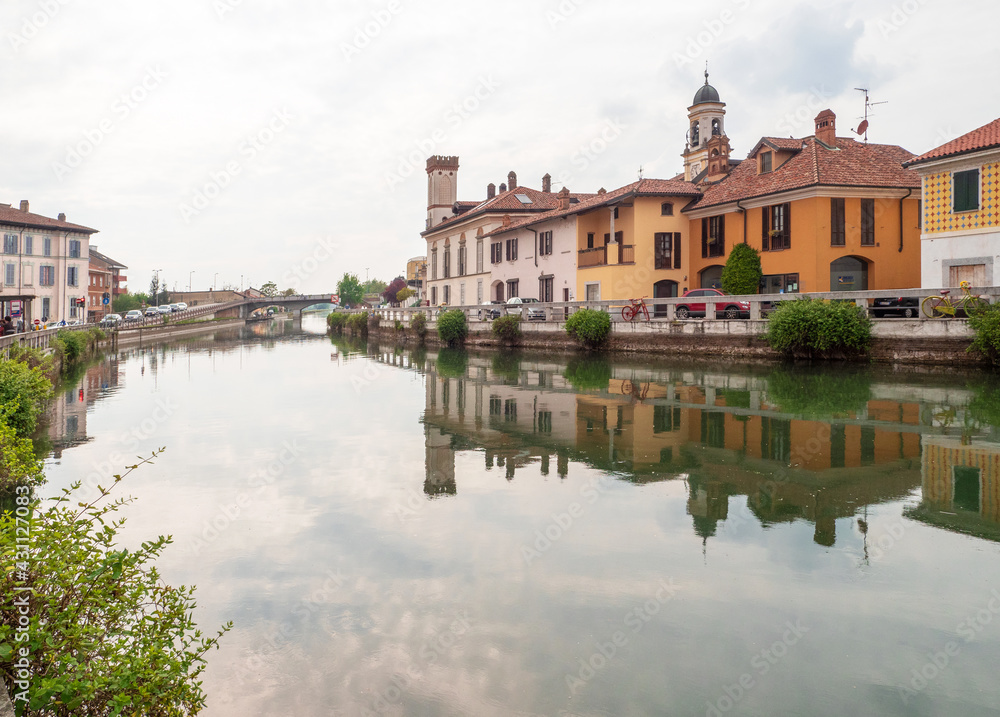 cityscape of Gaggiano, village near Milan crossed by the navigable canal called Naviglio Grande on a cloudy day.Lombardy,Italy.