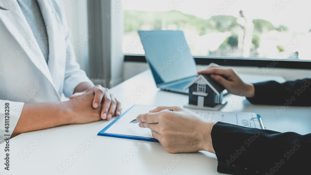 Real estate agent hand holding pen and explain the business contract, rent, buy, mortgage, loan, or home insurance Real estate agent hand holding pen and explain the business contract, rent, buy, mortgage, loan, or home insurance