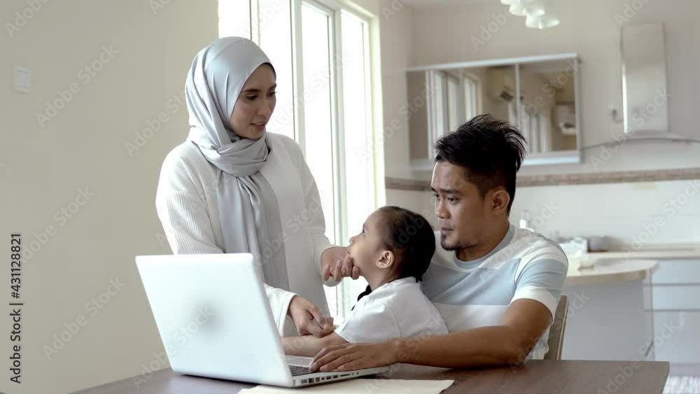 Father or husband working from home while child is sitting on his lap Father or husband working from home while child is sitting on his lap