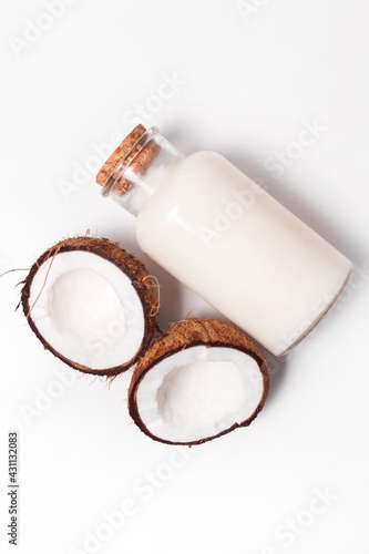 Top view organic coconut butter with fresh coconut pieces over white background