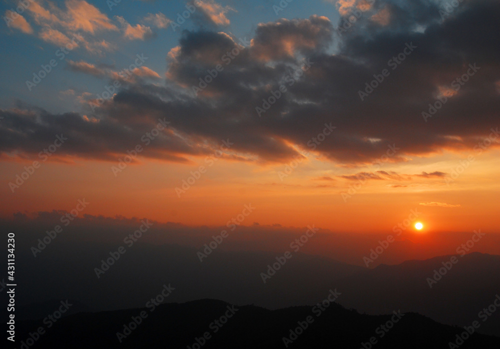 Tranquil scene of the sunset with Orange sky with cloud in the evening at doi pha hom pok national park Thailand. Twilight color