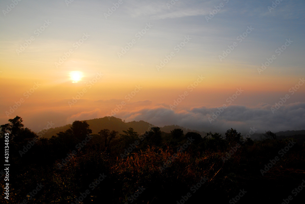 Landscape Tranquil scene of the sunrise with Orange sky and fog around the mountain in the morning at doi pha hom pok national park Thailand. Landscape Tranquil scene of the sunrise with Orange sky and fog around the mountain in the morning at doi pha hom pok national park Thailand.