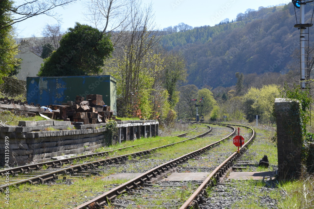 a pair of railway lines heading towards Llangollen station with signals on the side of the track