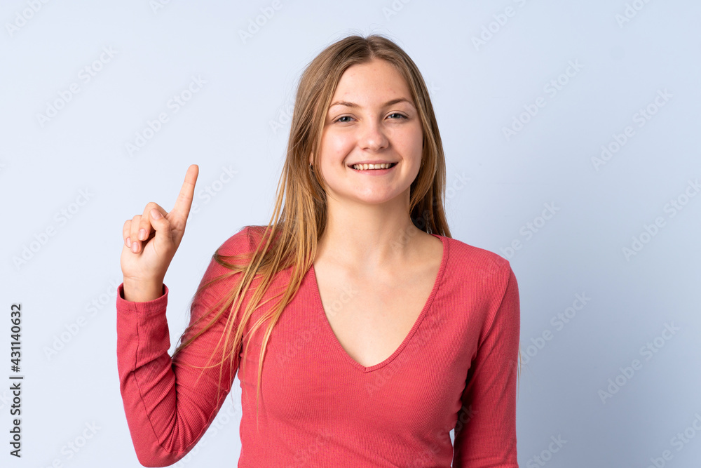 Teenager Ukrainian girl isolated on blue background pointing up a great idea Teenager Ukrainian girl isolated on blue background pointing up a great idea