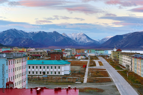 Aerial view of the port town in the Arctic. Empty street and colorful buildings. Northern settlement among the mountains. Travel to the Far North of Russia. Polar region. Egvekinot, Chukotka, Russia.