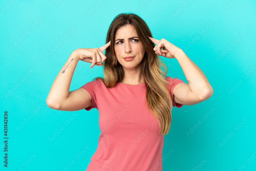 Young caucasian woman isolated on blue background having doubts and thinking Young caucasian woman isolated on blue background having doubts and thinking