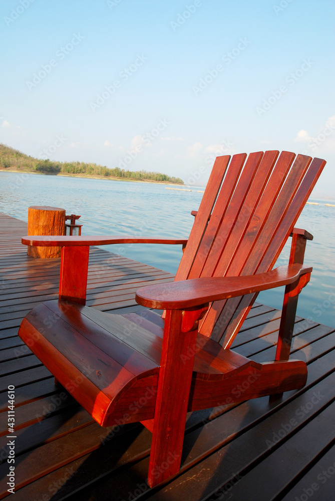 Brown Wooden chair over the lake - Chilling vibe on riverside - Relax time Brown Wooden chair over the lake - Chilling vibe on riverside - Relax time