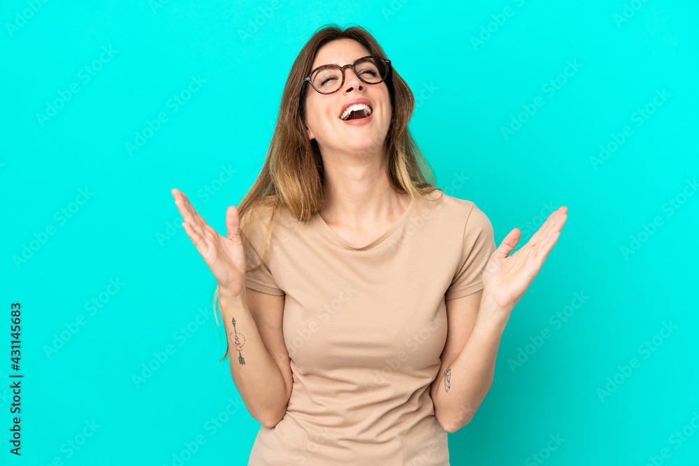 Young caucasian woman isolated on blue background smiling a lot Young caucasian woman isolated on blue background smiling a lot