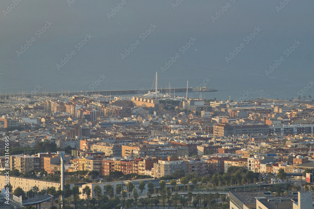 bird-eye view of a city and the port with the sea in the background