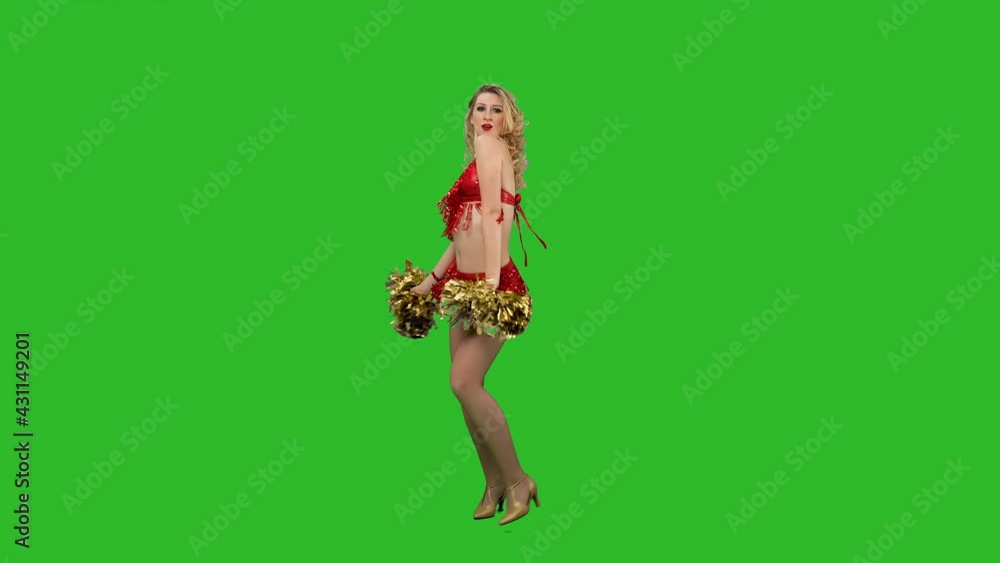 A cheering dance performed by a cheerleader in a red leotard with pompoms in her hands in the studio on a green screen. A charming girl moves her arms and hips, twirls and waves her hair. Slow motion. A cheering dance performed by a cheerleader in a red leotard with pompoms in her hands in the studio on a green screen. A charming girl moves her arms and hips, twirls and waves her hair. Slow motion.
