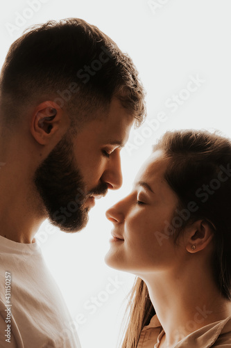Image of young happy man kissing and hugging beautiful woman
