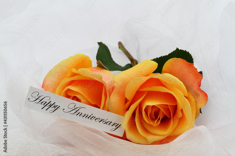 Happy Anniversary card with two orange roses on white textile