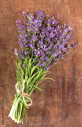 Branch of a lavenderon a wooden table