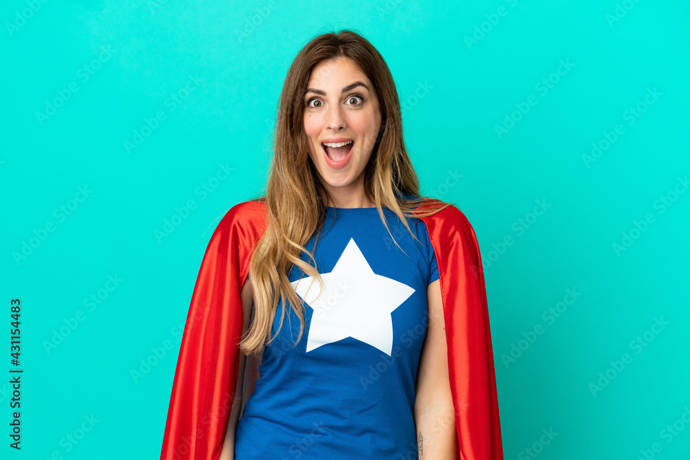 Super Hero caucasian woman isolated on blue background with surprise facial expression Super Hero caucasian woman isolated on blue background with surprise facial expression