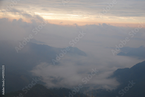 Landscape Nature scene landscape of Fog and Misty in the valley with light of sunrise in the morning of winter season at Phu Chi Fa , Chiangrai , Thailand 