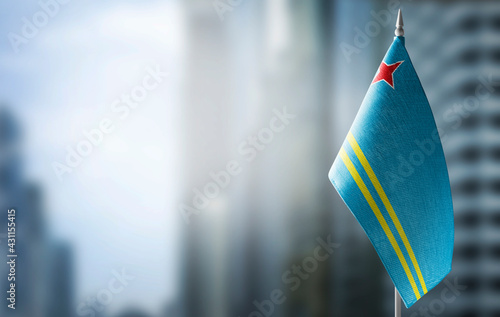 A small flag of Aruba on the background of a blurred background