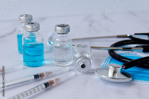 Vials and syringe on light background. Vaccination and immunization.