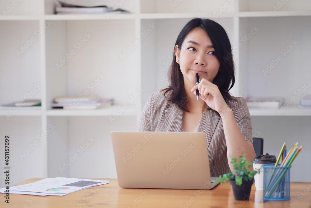 Businesswoman asia pondering over ideas for new business project. Woman using laptop while sitting at home. Businesswoman asia pondering over ideas for new business project. Woman using laptop while sitting at home.