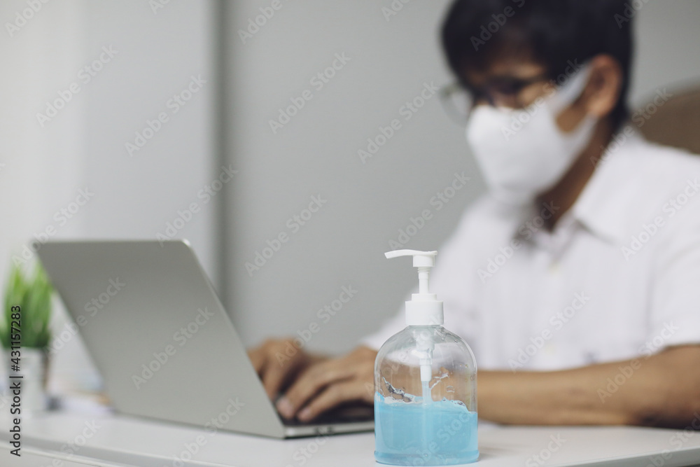 Asian man working at home and disinfect hand with antibacterial gel. Asian man working at home and disinfect hand with antibacterial gel.