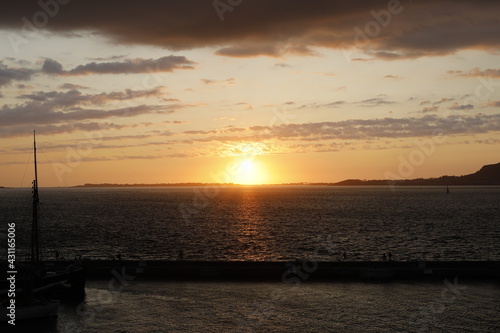 sunset over the sea, sun at the limit of the horizon, orange color sky, seascape