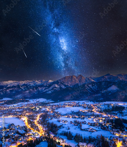 Obraz na płótnie Milky way over illuminated Zakopane city in winter w salonie