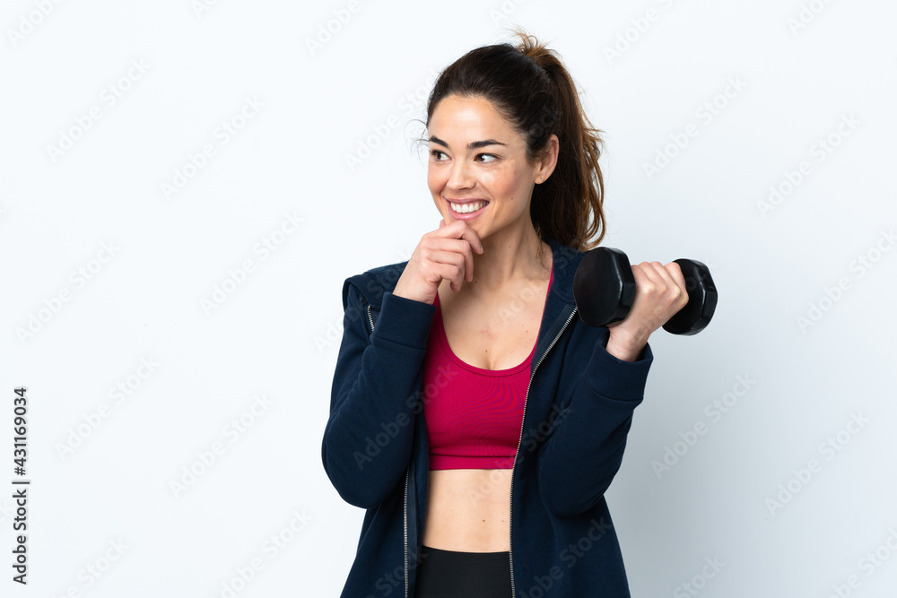 Sport woman making weightlifting over isolated white background thinking an idea and looking side Sport woman making weightlifting over isolated white background thinking an idea and looking side