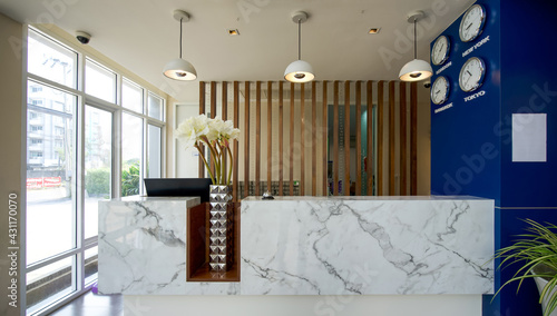 Canvas Print A long white marble reception counter located in the hotel lobby.