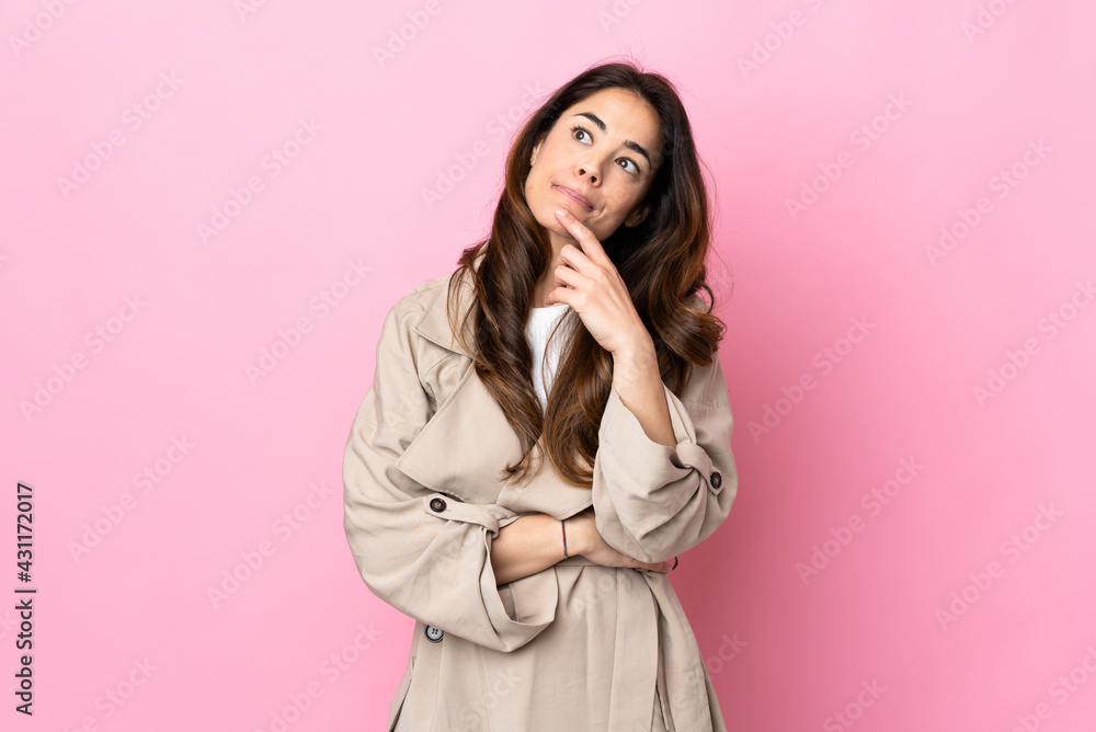 Woman over isolated background looking up while smiling Woman over isolated background looking up while smiling