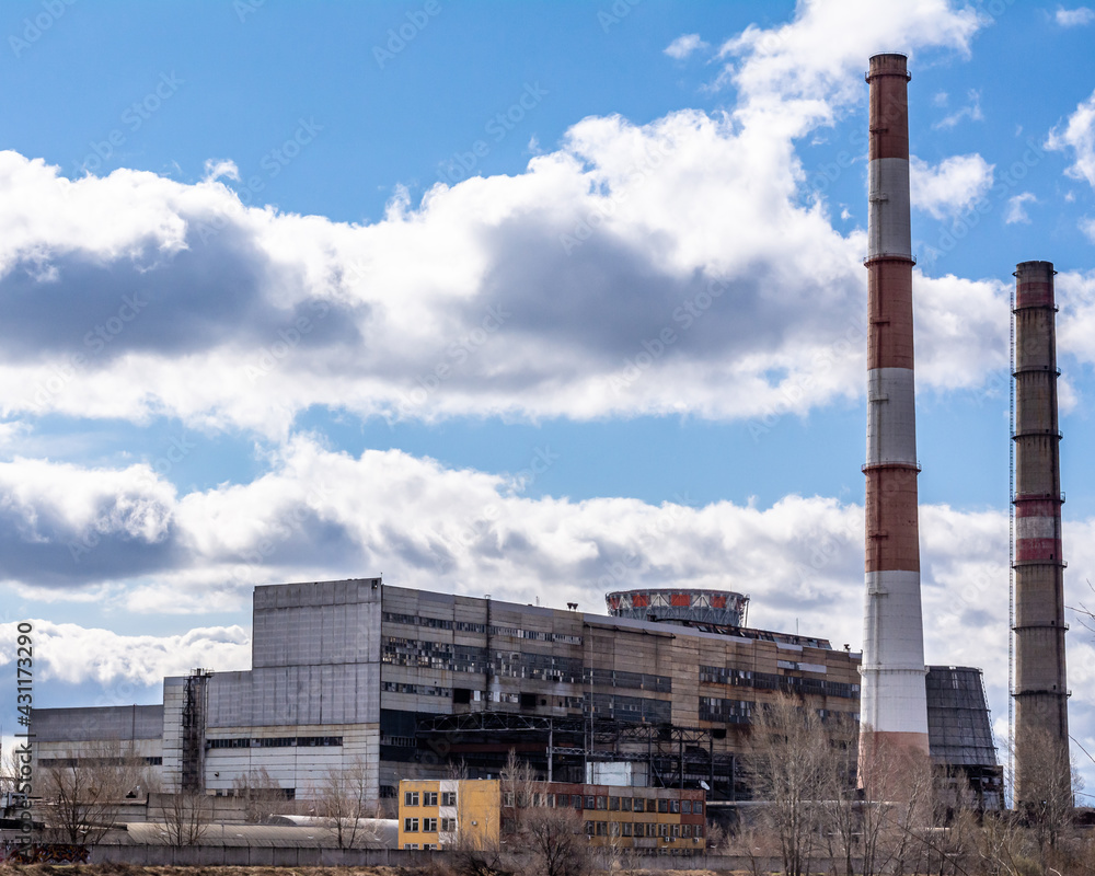 Thermal power plant, close-up against the blue sky. Concept: industrial enterprises and ecology. Environmental pollution. Thermal power plant, close-up against the blue sky. Concept: industrial enterprises and ecology. Environmental pollution.