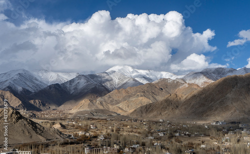 beautiful landscape of mountains with sun over them in ladakh. captured during snowfall.