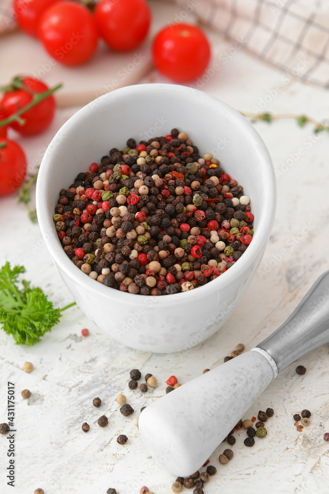 Mortar and pestle with peppercorns on light background Mortar and pestle with peppercorns on light background